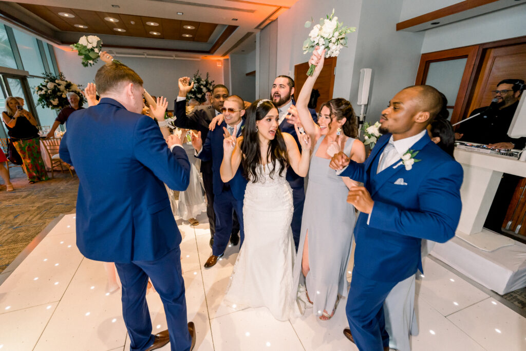 wedding couple having fun on the dance floor with wedding party